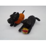 A vintage Schuco clockwork tinplate dog, along with another similar in the form of a cat playing