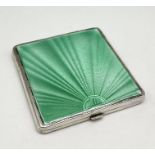 An Art Deco silver compact decorated with green guilloche enamel- slight chip to enamel