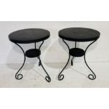 A pair of circular metal painted garden tables