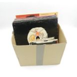 A collection of 12" and 7" vinyl records including Queen, The Rolling Stones, Led Zeppelin, The Who,