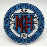 A round enamel sign for "The Newquay Hotels & Caterers Association" - 23cm diameter