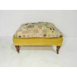 A Howard and Sons turn of the century footstool with applied tapestried cushion to top, raised on