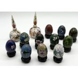 A collection of miniature Cloisonné eggs on stands along with two snuff bottles marked Istanbul