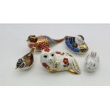 A collection of five unboxed Royal Crown Derby paperweights including a seal, pheasant, duck,