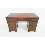 A reproduction kneehole desk with red leather inset top - length 122cm, depth 61cm, height 74cm