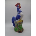 A large ceramic cockerel, with repair to crown. Approximate height 57cm
