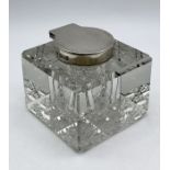 A silver topped cut glass inkwell