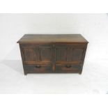 A Georgian oak mule chest with panelled detailing and two drawers under - length 130cm, depth