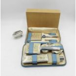 A Ronson table lighter along with a vintage boxed dressing table set