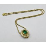 An emerald and diamond pendant set in 18ct gold with an 18ct gold chain, emerald measures approx.