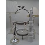 A silver plated candlestick, a cake stand, two decorated wooden finials and two classical style