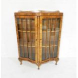 A walnut veneered display cabinet with serpentine front - length 93cm, depth 41cm, height 123cm