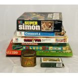 A collection of classic board games including Cluedo, Ludo, Super Simon, Monopoly board, Scrabble,