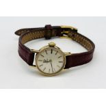 A ladies 9ct gold Omega watch on leather strap