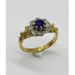 An amethyst and diamond cluster ring set in 18ct gold