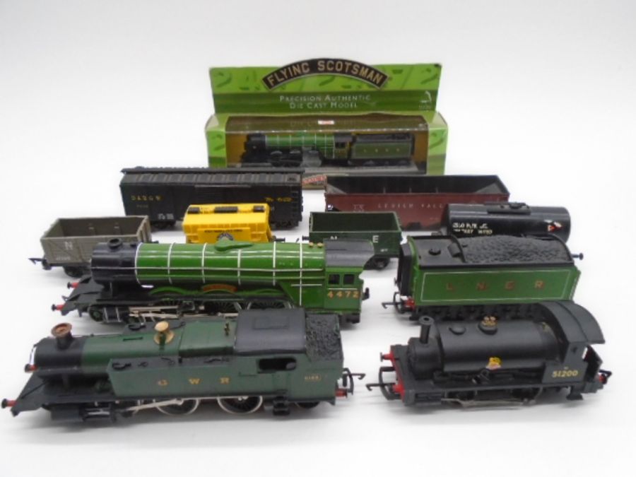 A collection of unboxed model railway OO gauge locomotives and rolling stock including a Mainline