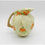 A Bewley pottery jug with floral decoration - height 21cm