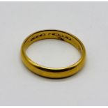 An 18ct gold wedding band, weight 5.4g