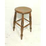 An elm kitchen stool with turned legs