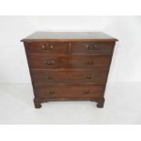 A Georgian mahogany chest of five drawers with boxwood stringing raised on bracket feet - length