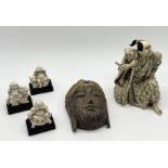 A collection of Eastern inspired resin figures along with carved wooden Buddha head