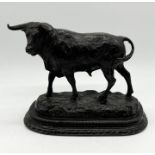 A bronze model of a Spanish bull on base signed J Cueva - height 26cm