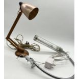 A copper and wood Anglepoise style lamp along with a desk top light by The Daylight Company