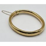 A 9ct gold hinged bangle, weight 11.5g