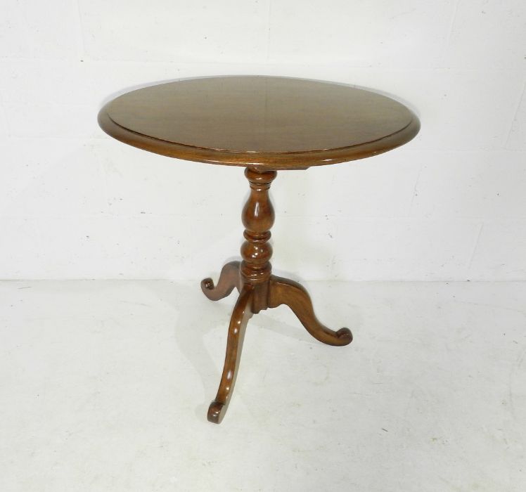 A Victorian oval tripod table