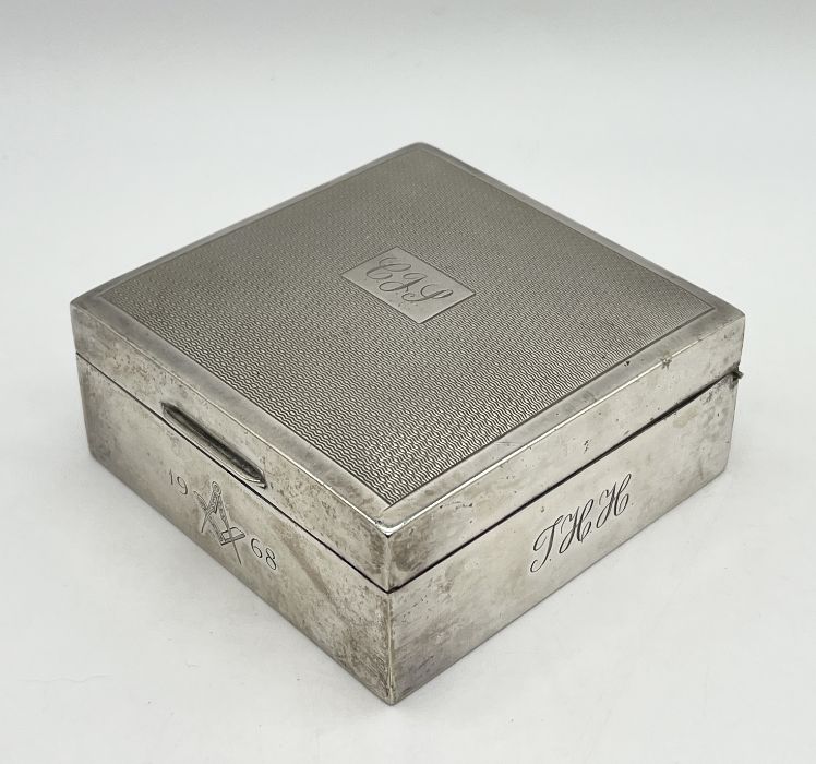 A silver cigarette box with engine turned decoration and Masonic symbol to front, dated 1968 - Image 2 of 4