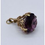 A 9ct gold fob set with an amethyst coloured stone