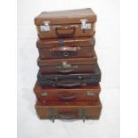 A collection of six vintage leather suitcases