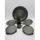 An 18th century pewter charger, pewter warming plates, tankards etc.(charger approx.41cm diameter)