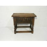 A turn of the century oak lidded coffee table with carved detailing - length 51cm, height 47cm,