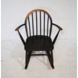 A child's Ercol dark wood rocking chair