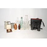 A pair of Tasco 5003RB 10 x 40mm binoculars with case, along with a small quantity of glass bottles,