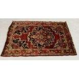An Eastern red ground rug - overall size 205cm x 138cm