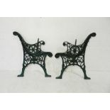 A pair of painted cast iron garden bench ends