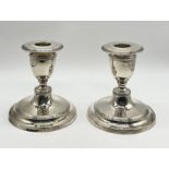A pair of silver dwarf candlesticks