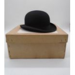 A boxed Bowler hat in original packaging, size 7 and 1/8, made by Herbert Johnson Ltd. Marked with