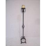 A tall wrought iron vintage candlestick holder.