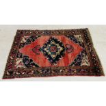 An Eastern red ground rug - overall size 210cm x 149cm