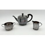 An Art Deco hallmarked silver three piece tea set with bakelite handle and finial to tea pot,