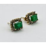 A pair of 14ct gold (tested) emerald and diamond earrings, the emeralds measuring 7mm x 5mm (approx.