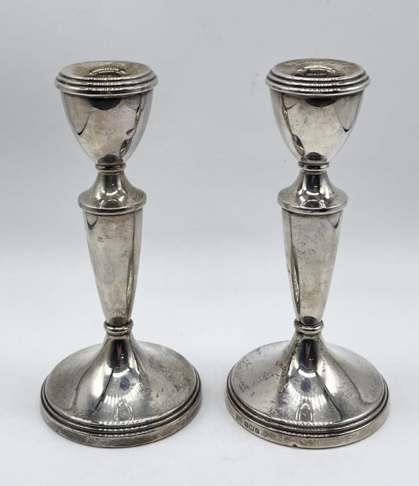 A pair of hallmarked silver candlesticks, height 14.5cm