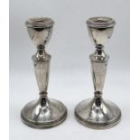 A pair of hallmarked silver candlesticks, height 14.5cm
