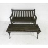 A wooden garden bench along with a cast iron framed garden coffee table with wooden slatted top