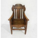 A turn of the century oak carver chair with carved detailing