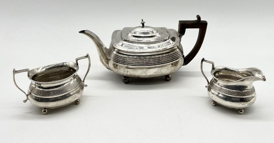 A hallmarked silver Georgian tea pot, London 1807 with a matched sugar and cream jug - Sheffield