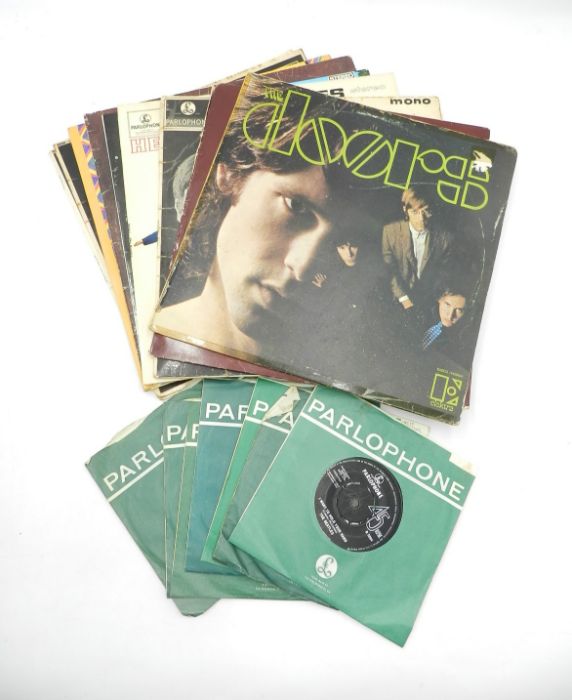 A small collection of 12" and 7" vinyl records comprising of The Doors, The Beatles, Paul and